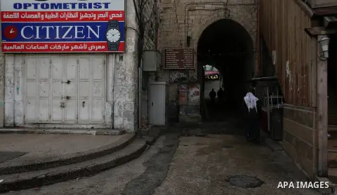 Palestinians walk past closed shops during a general strike over U.S. President Donald Trump's decision to recognize Jerusalem as the capital of Israel, in the West bank city of Nablus on December 7, 2017. Photo by Shadi...