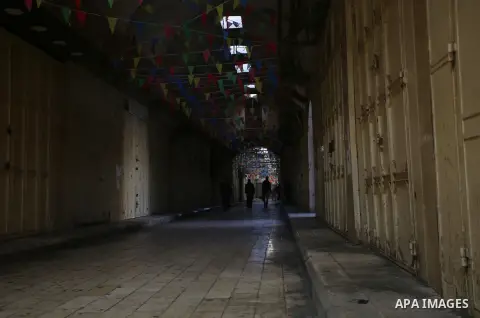 Palestinians walk past closed shops during a general strike over U.S. President Donald Trump's decision to recognize Jerusalem as the capital of Israel, in the West bank city of Nablus on December 7, 2017. Photo by Ayman...