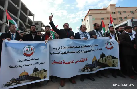 Palestinian lawyers take part in a protest following Trump's decision to recognise Jerusalem as the capital of Israel, in front of the headquarter United Nation "UNSCO" in Gaza City, on December 7, 2017. Photo by Mahmoud...