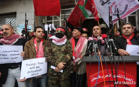 Palestinian militants from the Popular Front for the Liberation of Palestine (PFLP) take part in a protest following Trump's decision to recognise Jerusalem as the capital of Israel, in Gaza City, on December 7, 2017. Ph...