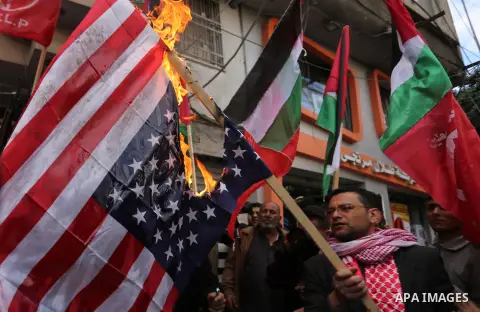 Palestinian militants of the Popular Front for the Liberation of Palestine (PFLP) burn an Israeli flag and a U.S. flag during a protest against following Trump's decision to recognise Jerusalem as the capital of Israel,...