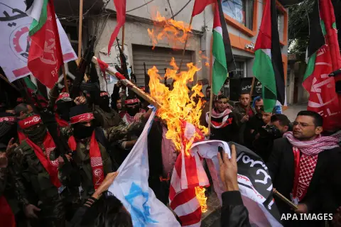 Palestinian militants of the Popular Front for the Liberation of Palestine (PFLP) burn an Israeli flag and a U.S. flag during a protest against following Trump's decision to recognise Jerusalem as the capital of Israel,...