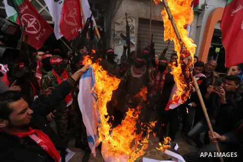 Palestinian militants of the Popular Front for the Liberation of Palestine (PFLP) burn an Israeli flag and a U.S. flag during a protest against following Trump's decision to recognise Jerusalem as the capital of Israel,...