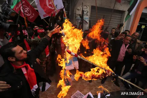 Palestinian militants of the Popular Front for the Liberation of Palestine (PFLP) burn an Israeli flag and a U.S. flag during a protest against following Trump's decision to recognise Jerusalem as the capital of Israel,...