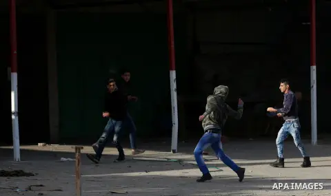 Palestinians throws stones at Israeli troops during clashes in Hawara checkpoint, south of the West Bank city of Nablus, following a demonstration against US President Donald Trump's decision to recognise Jerusalem as th...