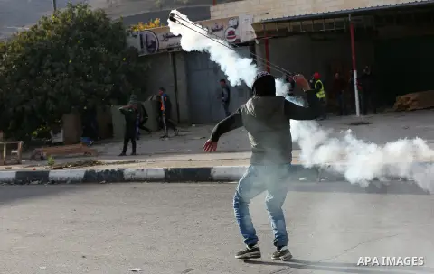 Palestinians throws stones at Israeli troops during clashes in Hawara checkpoint, south of the West Bank city of Nablus, following a demonstration against US President Donald Trump's decision to recognise Jerusalem as th...