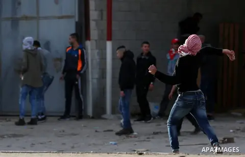 Palestinians throws stones at Israeli troops during clashes in Hawara checkpoint, south of the West Bank city of Nablus, following a demonstration against US President Donald Trump's decision to recognise Jerusalem as th...
