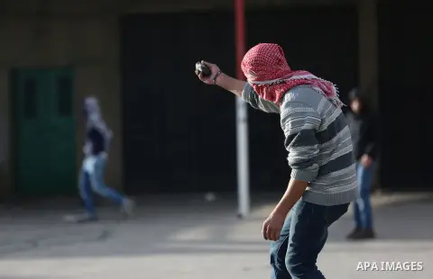 Palestinians throws stones at Israeli troops during clashes in Hawara checkpoint, south of the West Bank city of Nablus, following a demonstration against US President Donald Trump's decision to recognise Jerusalem as th...
