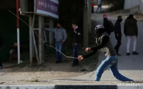 Palestinians throws stones at Israeli troops during clashes in Hawara checkpoint, south of the West Bank city of Nablus, following a demonstration against US President Donald Trump's decision to recognise Jerusalem as th...