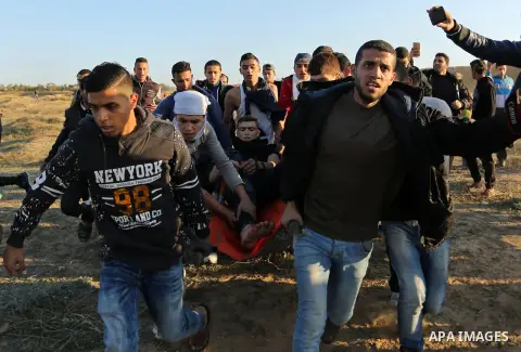 A wounded Palestinian protester is evacuated during clashes with Israeli forces at the Bureij refugee camp, in central Gaza on December 8, 2017. Palestinians clashed with Israeli security forces after calls for a "day of...