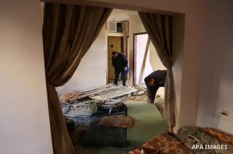 Palestinians inspect the damage at their house on December 9, 2017, in the aftermath of an Israeli air strike in Beit Lahia, in the northern Gaza Strip. Israel aircraft attacked Hamas military facilities in the Gaza Stri...
