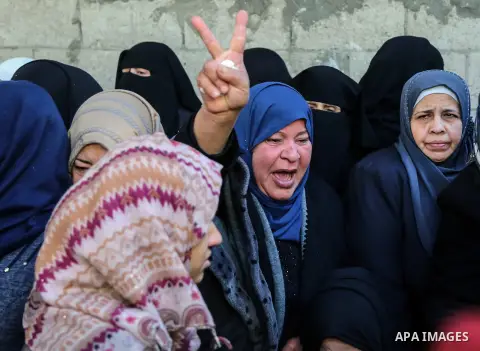 Relatives of Mahmoud al-Masri, a 30-year-old Palestinian man who was killed the previous day in clashes with Israeli troops, mourn during his funeral in Khan Younis, in the southern Gaza Strip, on December 9, 2017. Clash...