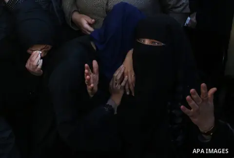 Relatives of Mahmoud al-Masri, a 30-year-old Palestinian man who was killed the previous day in clashes with Israeli troops, mourn during his funeral in Khan Younis, in the southern Gaza Strip, on December 9, 2017. Clash...