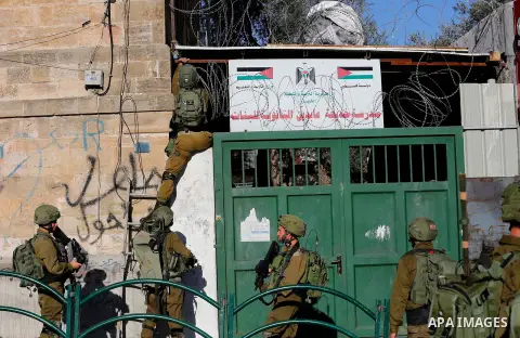 Israeli forces walk down a street during clashes with Palestinian demonstrators in Hebron in the Israeli-occupied West Bank on December 9, 2017, following the US president's controversial recognition of Jerusalem as Isra...