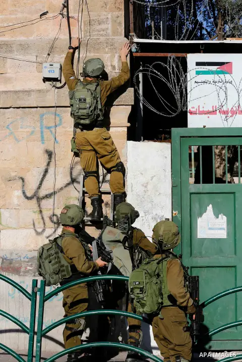Israeli forces walk down a street during clashes with Palestinian demonstrators in Hebron in the Israeli-occupied West Bank on December 9, 2017, following the US president's controversial recognition of Jerusalem as Isra...