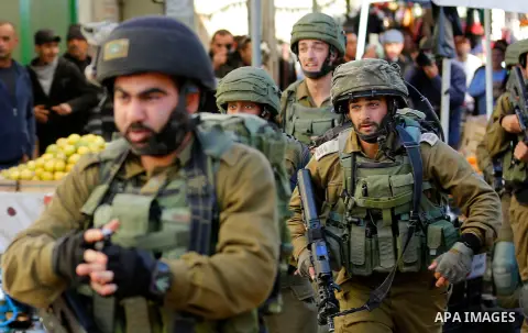 Israeli forces walk down a street during clashes with Palestinian demonstrators in Hebron in the Israeli-occupied West Bank on December 9, 2017, following the US president's controversial recognition of Jerusalem as Isra...