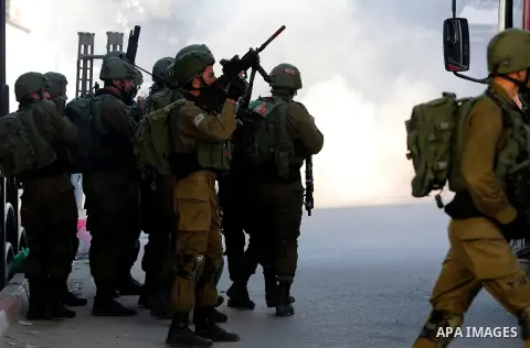 Israeli forces walk down a street during clashes with Palestinian demonstrators in Hebron in the Israeli-occupied West Bank on December 9, 2017, following the US president's controversial recognition of Jerusalem as Isra...