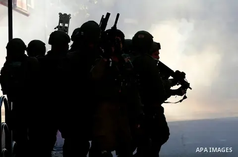 Israeli forces walk down a street during clashes with Palestinian demonstrators in Hebron in the Israeli-occupied West Bank on December 9, 2017, following the US president's controversial recognition of Jerusalem as Isra...