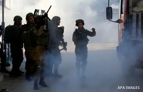 Israeli forces walk down a street during clashes with Palestinian demonstrators in Hebron in the Israeli-occupied West Bank on December 9, 2017, following the US president's controversial recognition of Jerusalem as Isra...