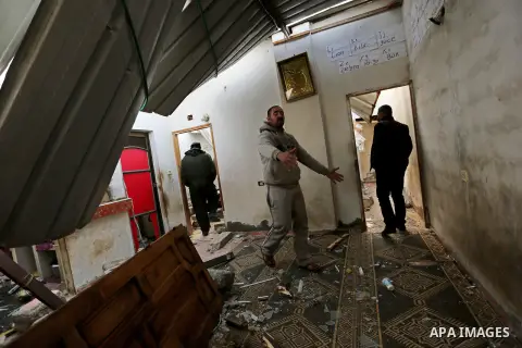 Palestinians inspect their house that was damaged in an Israeli airstrike on a nearby Hamas base, in Khan Yunis town in the southern Gaza Strip in December 13, 2017. Photo by Ashraf Amra