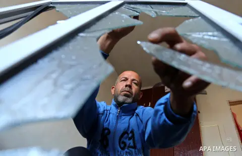 A Palestinian man inspects his house that was damaged in an Israeli airstrike on a nearby Hamas base, in Khan Yunis town in the southern Gaza Strip in December 13, 2017. Photo by Ashraf Amra
