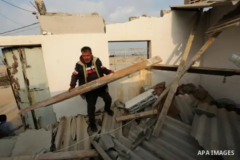 A Palestinian man inspects his house that was damaged in an Israeli airstrike on a nearby Hamas base, in Khan Yunis town in the southern Gaza Strip in December 13, 2017. Photo by Ashraf Amra