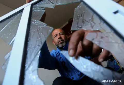 A Palestinian man inspects his house that was damaged in an Israeli airstrike on a nearby Hamas base, in Khan Yunis town in the southern Gaza Strip in December 13, 2017. Photo by Ashraf Amra