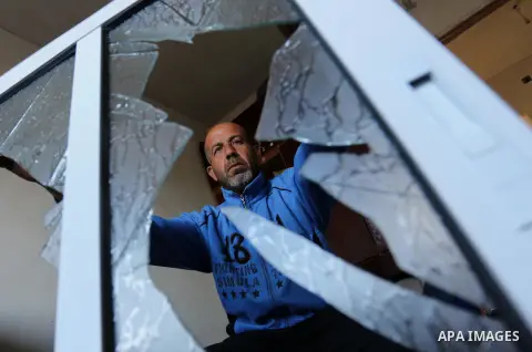 A Palestinian man inspects his house that was damaged in an Israeli airstrike on a nearby Hamas base, in Khan Yunis town in the southern Gaza Strip in December 13, 2017. Photo by Ashraf Amra