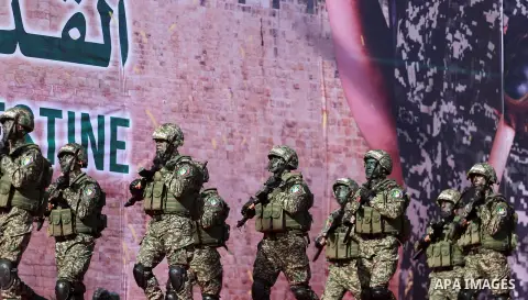 Hamas militants take part in a rally marking the 30th anniversary of the founding of the Islamist movement, in Gaza City, on December 14, 2017. Photo by Mohammed Asad