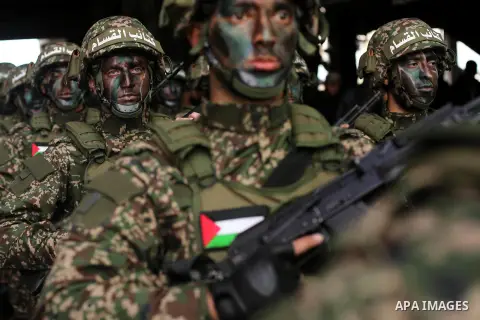 Palestinian members of the Qassam brigades, the militia wing of Hamas movement, attend a rally marking the 30th anniversary of their group, in Gaza City, Thursday, Dec. 14, 2017. Photo by Ashraf Amra