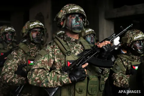 Palestinian members of the Qassam brigades, the militia wing of Hamas movement, attend a rally marking the 30th anniversary of their group, in Gaza City, Thursday, Dec. 14, 2017. Photo by Ashraf Amra