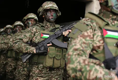 Palestinian members of the Qassam brigades, the militia wing of Hamas movement, attend a rally marking the 30th anniversary of their group, in Gaza City, Thursday, Dec. 14, 2017. Photo by Ashraf Amra