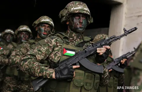 Palestinian members of the Qassam brigades, the militia wing of Hamas movement, attend a rally marking the 30th anniversary of their group, in Gaza City, Thursday, Dec. 14, 2017. Photo by Ashraf Amra