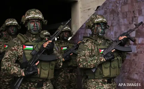 Palestinian members of the Qassam brigades, the militia wing of Hamas movement, attend a rally marking the 30th anniversary of their group, in Gaza City, Thursday, Dec. 14, 2017. Photo by Ashraf Amra
