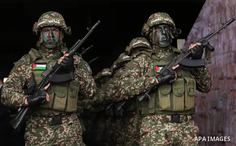 Palestinian members of the Qassam brigades, the militia wing of Hamas movement, attend a rally marking the 30th anniversary of their group, in Gaza City, Thursday, Dec. 14, 2017. Photo by Ashraf Amra