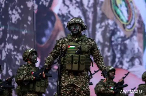 Armed members of the Qassam Brigades, the militia wing of Hamas movement, attend a rally marking the 30th anniversary of Hamas in Gaza City, Gaza, 14 December 2017. Photo by Mohammed Dahman
