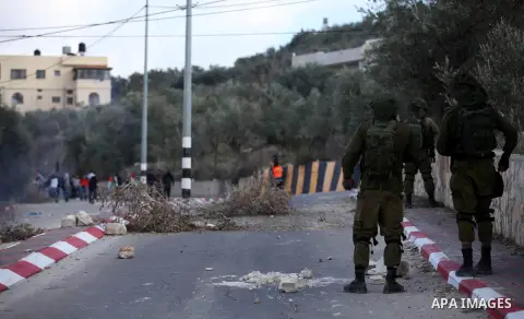 Palestinian protestors, from the nearby Palestinian village of Naqura, confront Israeli security forces close to the Jewish settlement of Shavei Shomron near the West Bank city of Tulkarem on December 14, 2017, as protes...