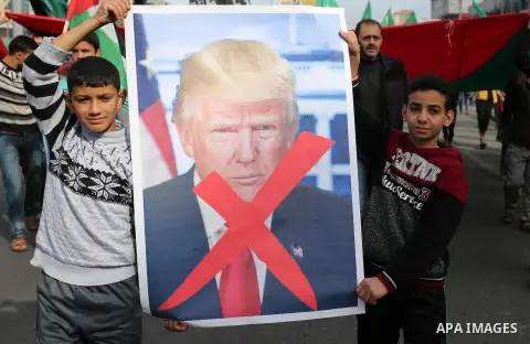Palestinians take part during a protest against US President Donald Trump's decision to recognise Jerusalem as the capital of Israel, in al-Bureij in the central of Gaza strip, on December 15, 2017. Thousands of Palestin...