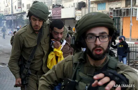 Israeli security forces arrest a Palestinian protester during clashes in the city centre of the occupied West Bank town of Hebron on December 15, 2017 as demonstrations continue to flare in the Middle East and elsewhere...