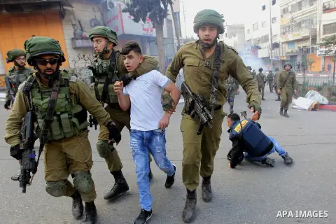 Israeli security forces arrest a Palestinian protester during clashes in the city centre of the occupied West Bank town of Hebron on December 15, 2017 as demonstrations continue to flare in the Middle East and elsewhere...