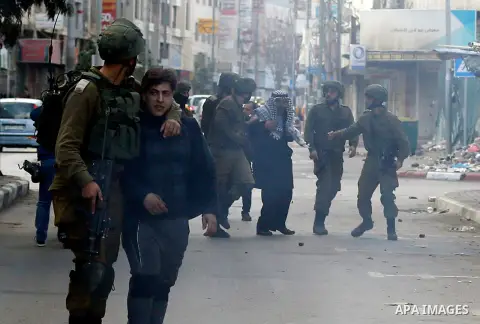 Israeli security forces arrest a Palestinian protester during clashes in the city centre of the occupied West Bank town of Hebron on December 15, 2017 as demonstrations continue to flare in the Middle East and elsewhere...
