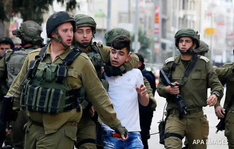 Israeli security forces arrest a Palestinian protester during clashes in the city centre of the occupied West Bank town of Hebron on December 15, 2017 as demonstrations continue to flare in the Middle East and elsewhere...
