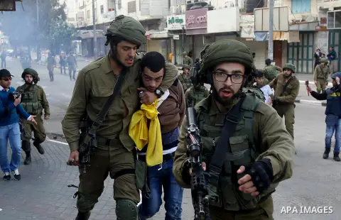 Israeli security forces arrest a Palestinian protester during clashes in the city centre of the occupied West Bank town of Hebron on December 15, 2017 as demonstrations continue to flare in the Middle East and elsewhere...