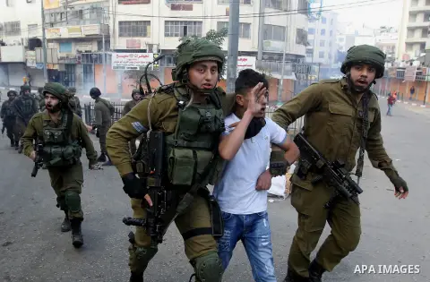 Israeli security forces arrest a Palestinian protester during clashes in the city centre of the occupied West Bank town of Hebron on December 15, 2017 as demonstrations continue to flare in the Middle East and elsewhere...