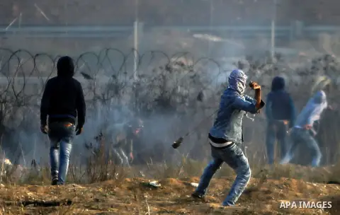 Palestinian protesters clash with Israeli security forces near the border fence with Israel, east of Gaza City on December 15, 2017 as demonstrations continue over US President Donald Trump's declaration of Jerusalem as...