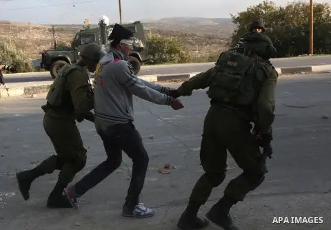Israeli security forces arrest aPalestinian protester during clashes near the Huwara checkpoint, south of Nablus in the Israeli-occupied West Bank, on December 15, 2017, as protests continue in the region amid anger over...