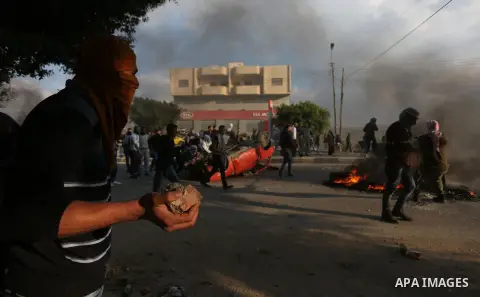 Israeli border clash with Palestinian protesters near the Huwara checkpoint, south of Nablus in the Israeli-occupied West Bank, on December 15, 2017, as protests continue in the region amid anger over US President Donald...