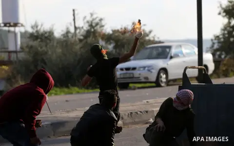 Israeli border clash with Palestinian protesters near the Huwara checkpoint, south of Nablus in the Israeli-occupied West Bank, on December 15, 2017, as protests continue in the region amid anger over US President Donald...