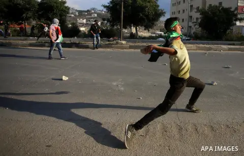 Israeli border clash with Palestinian protesters near the Huwara checkpoint, south of Nablus in the Israeli-occupied West Bank, on December 15, 2017, as protests continue in the region amid anger over US President Donald...