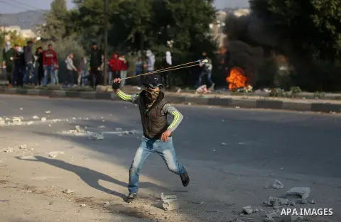 Israeli border clash with Palestinian protesters near the Huwara checkpoint, south of Nablus in the Israeli-occupied West Bank, on December 15, 2017, as protests continue in the region amid anger over US President Donald...